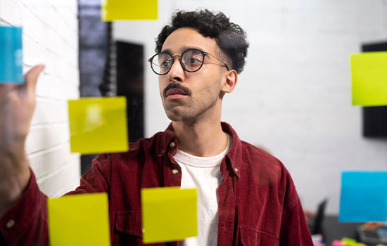 medium-shot-man-sticking-post-its_23-2149362898