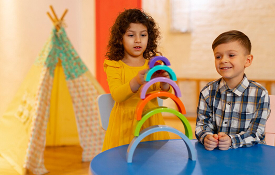 young-boy-girl-playing-indoors-with-eco-toys_23-2150268062